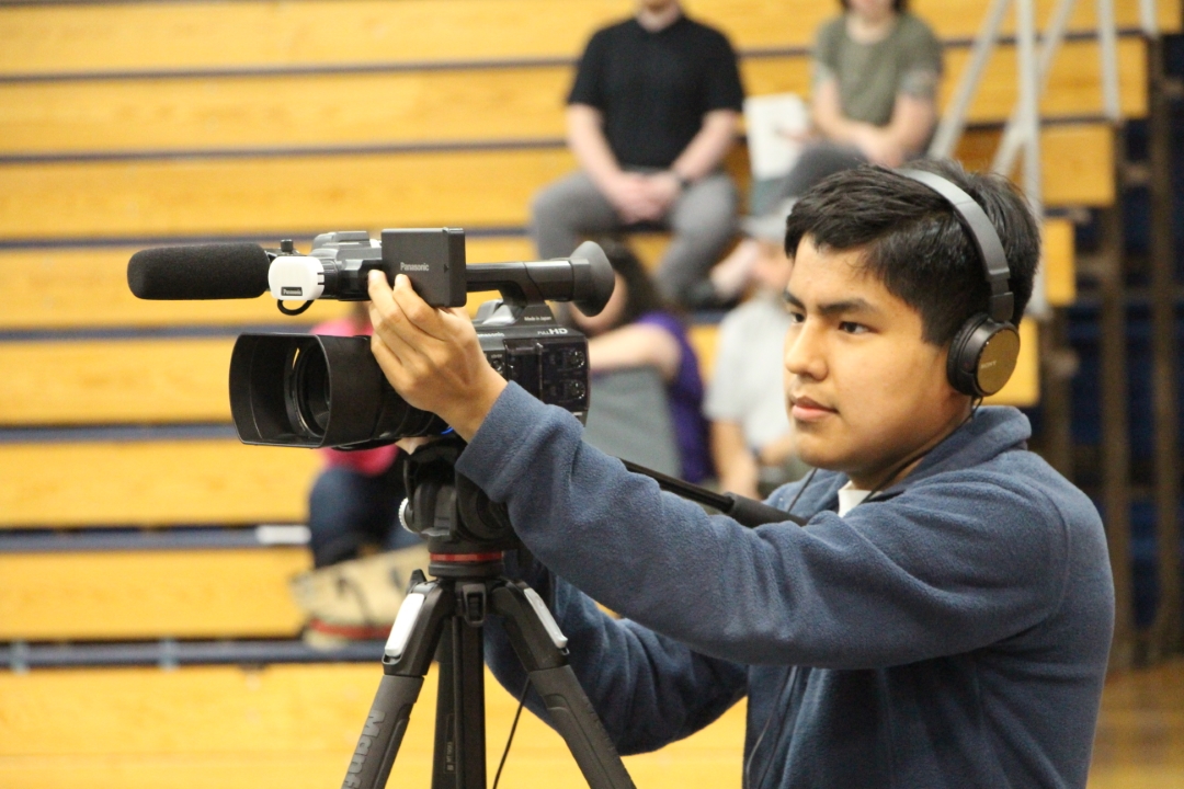 Sam recording a graduation ceremony.